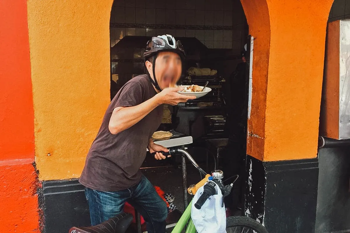 Biking food tour participant with a plate of Mexican food