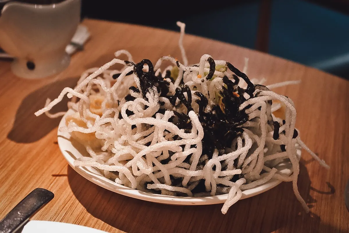 Squid in pancit palabok at a restaurant in Metro Manila