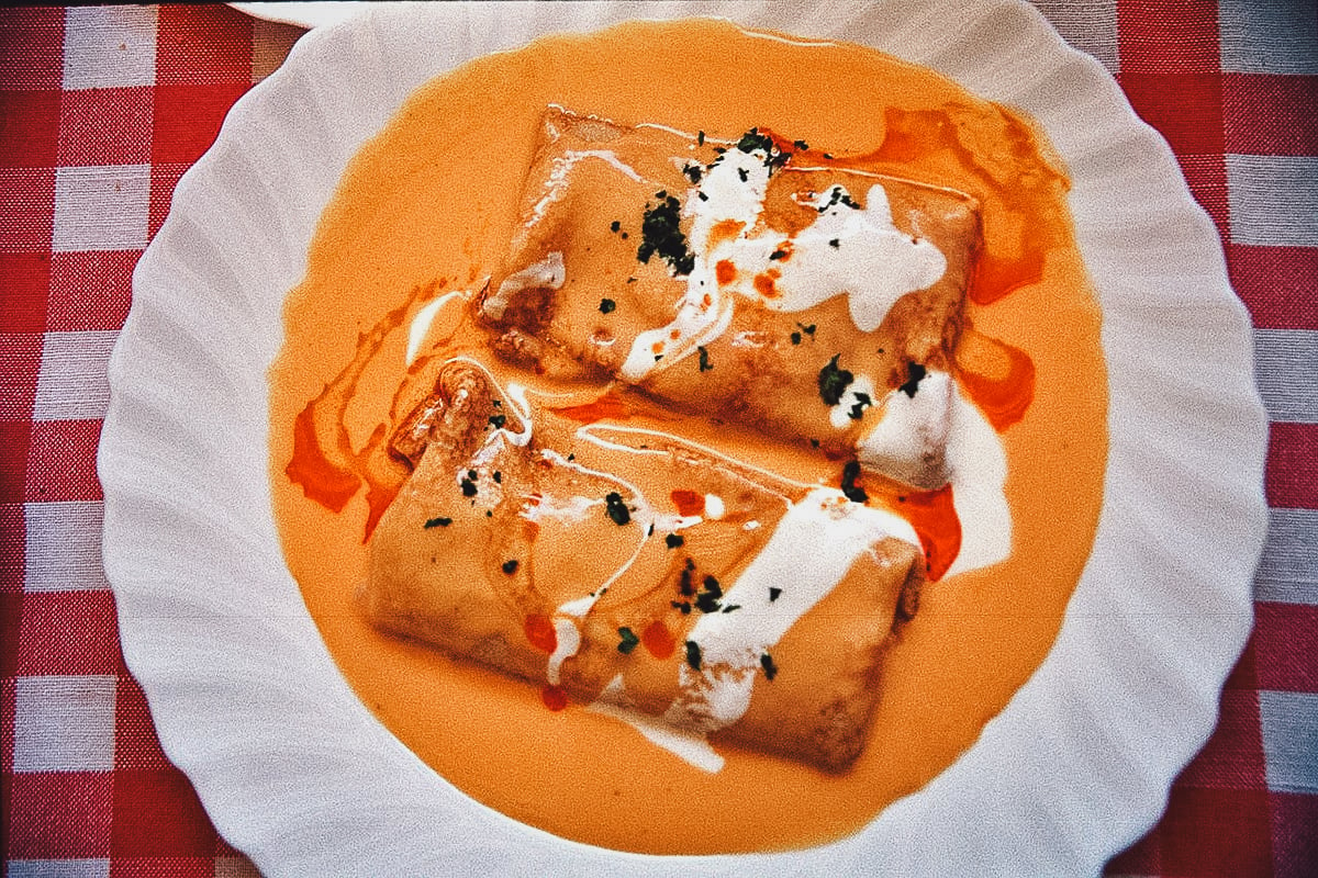 Hungarian hortobagyi palacsinta topped with sour cream