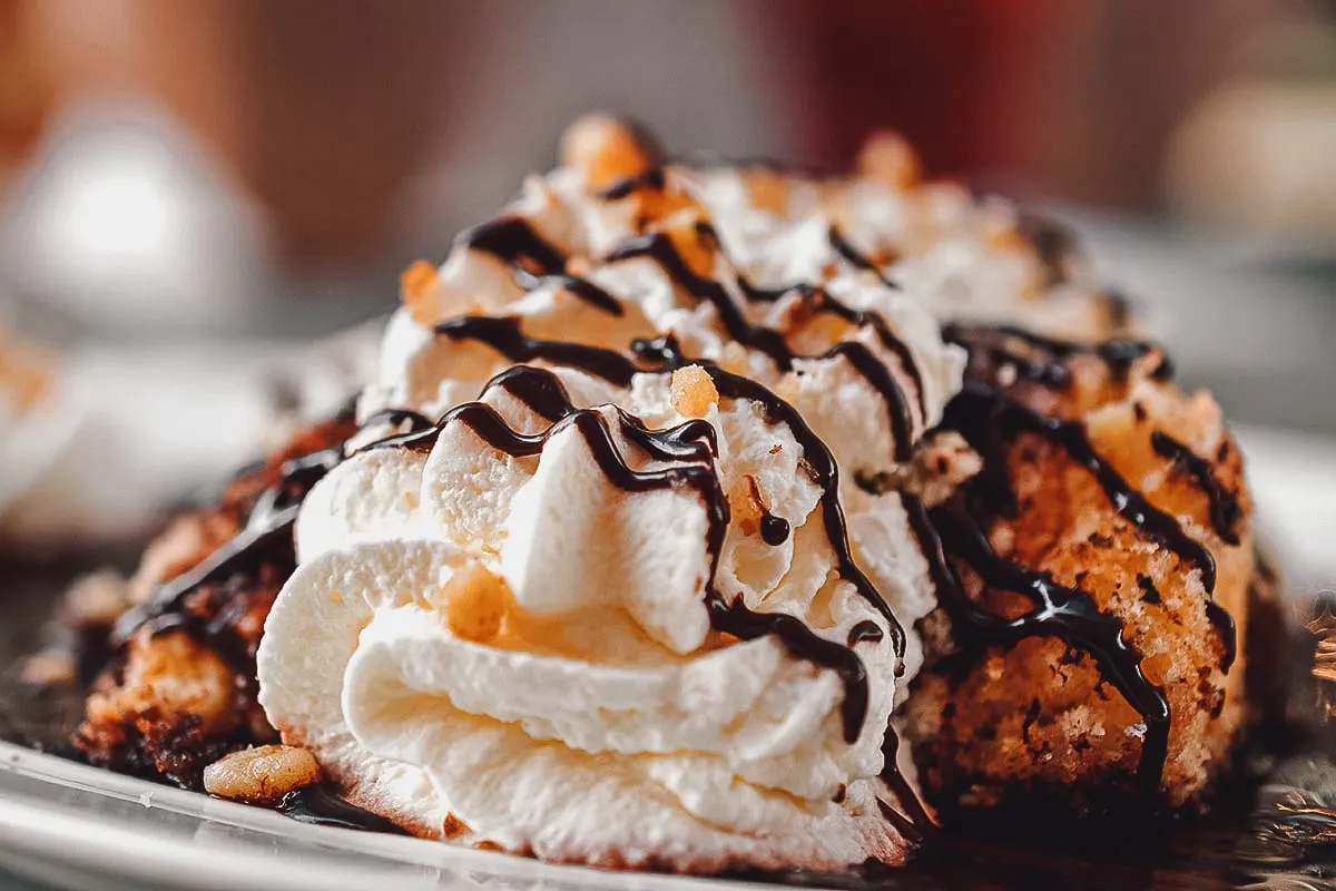 Hungarian somloi galuska topped with whipped cream