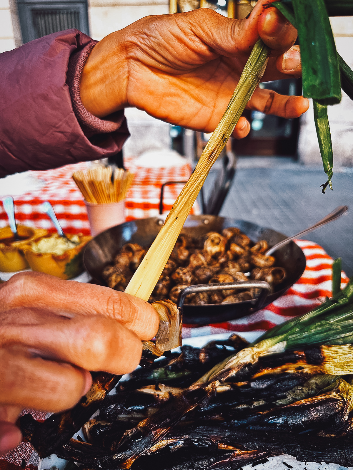 Eating a calcot at a restaurant in Barcelona