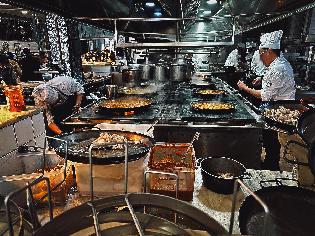 Chefs making paella in the restaurant kitchen