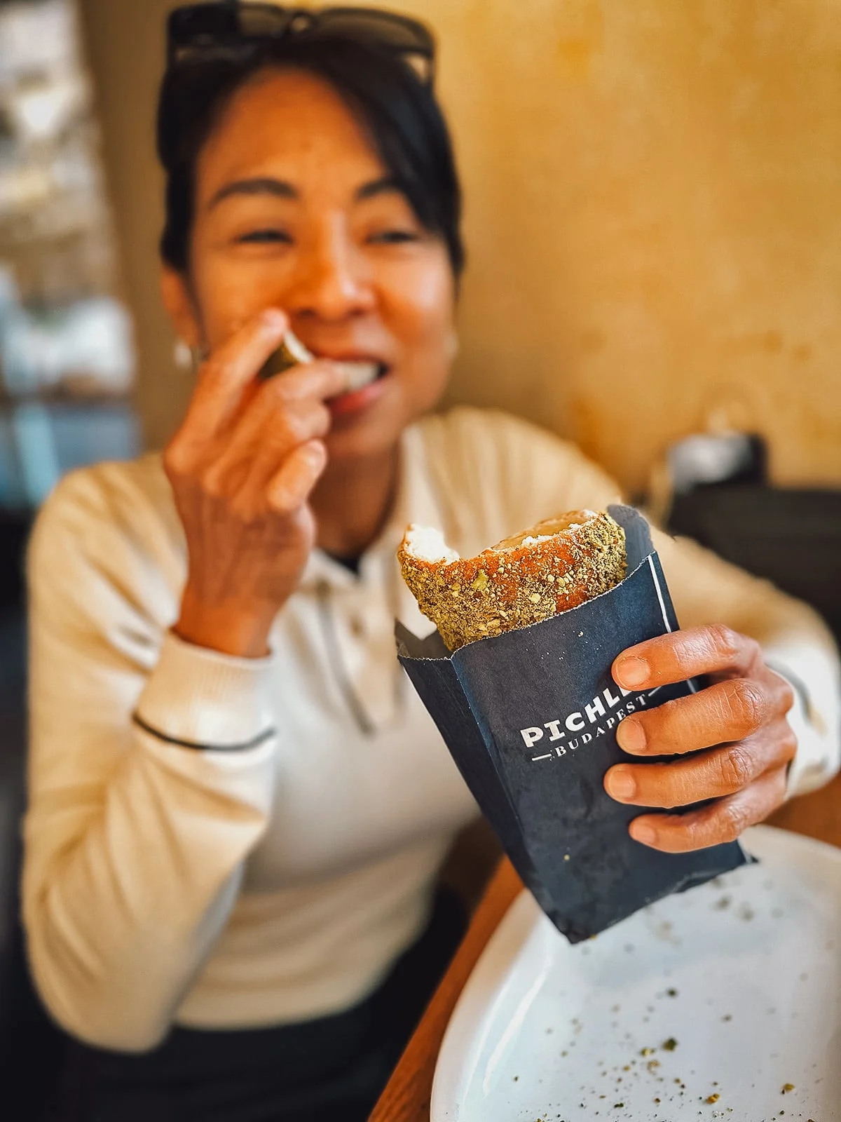 Woman eating Hungarian chimney cake at Pichler
