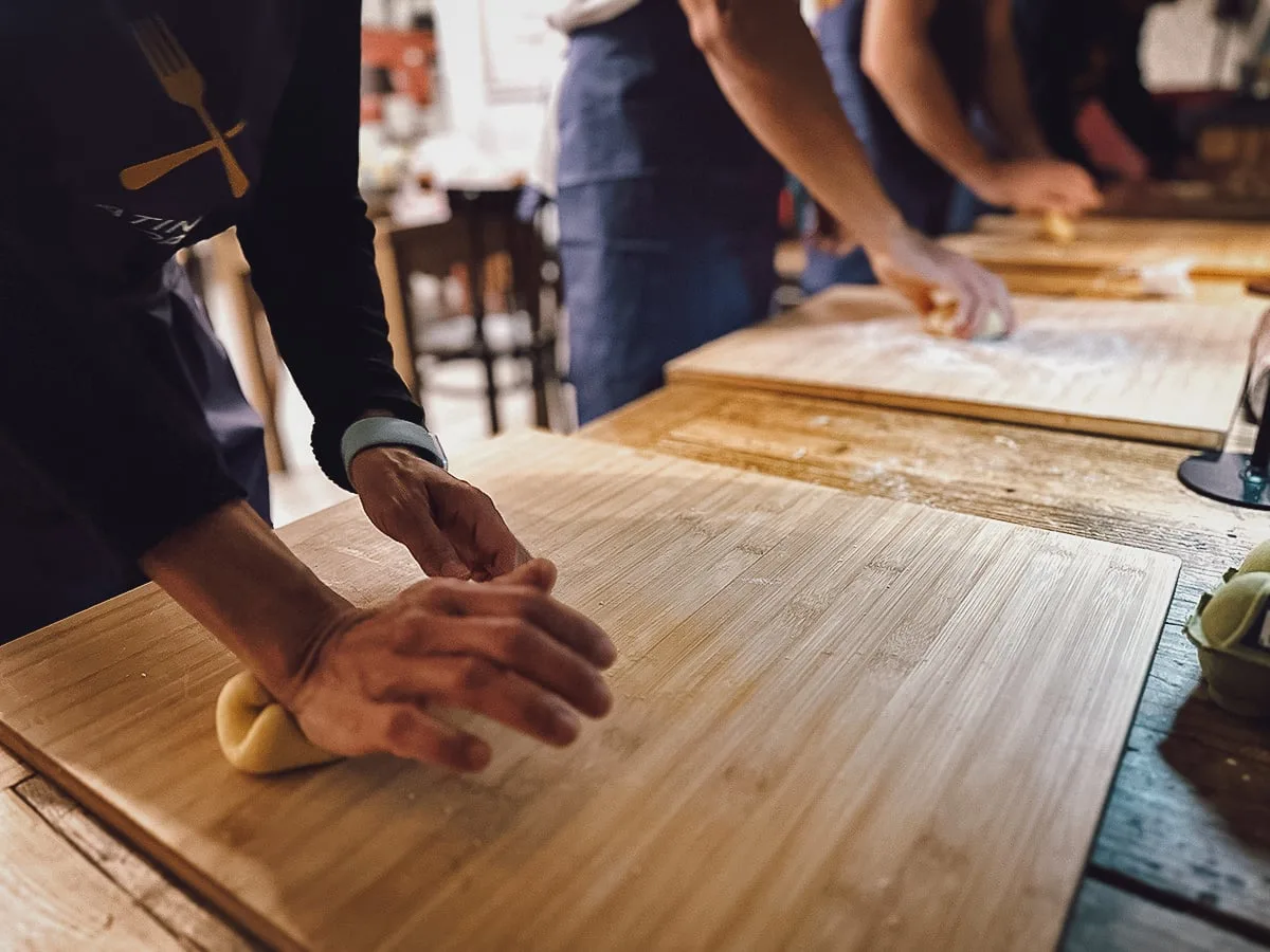 Pasta Cooking Class in Rome Tourists in Rome kneading dough