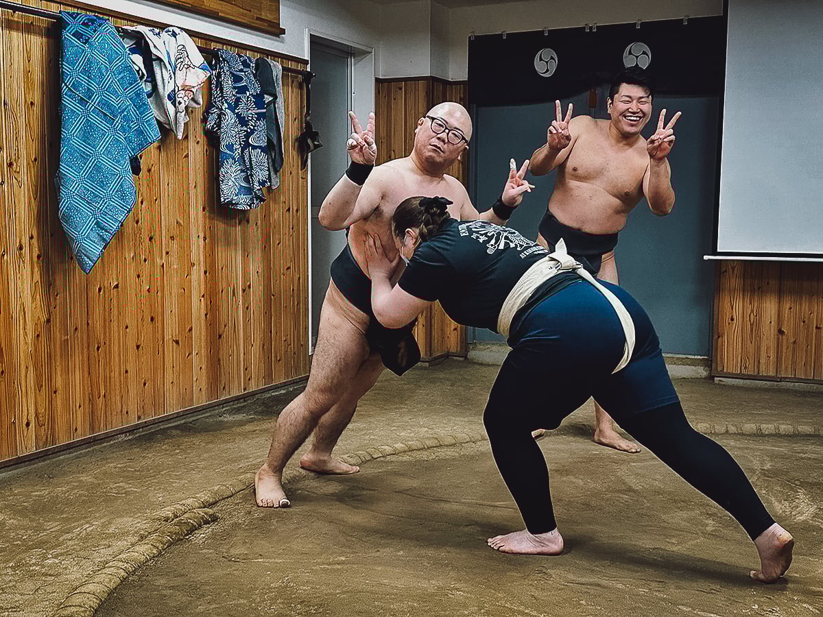 Sumo Experience in Tokyo Retired Sumo wrestler wrestling with a tourist