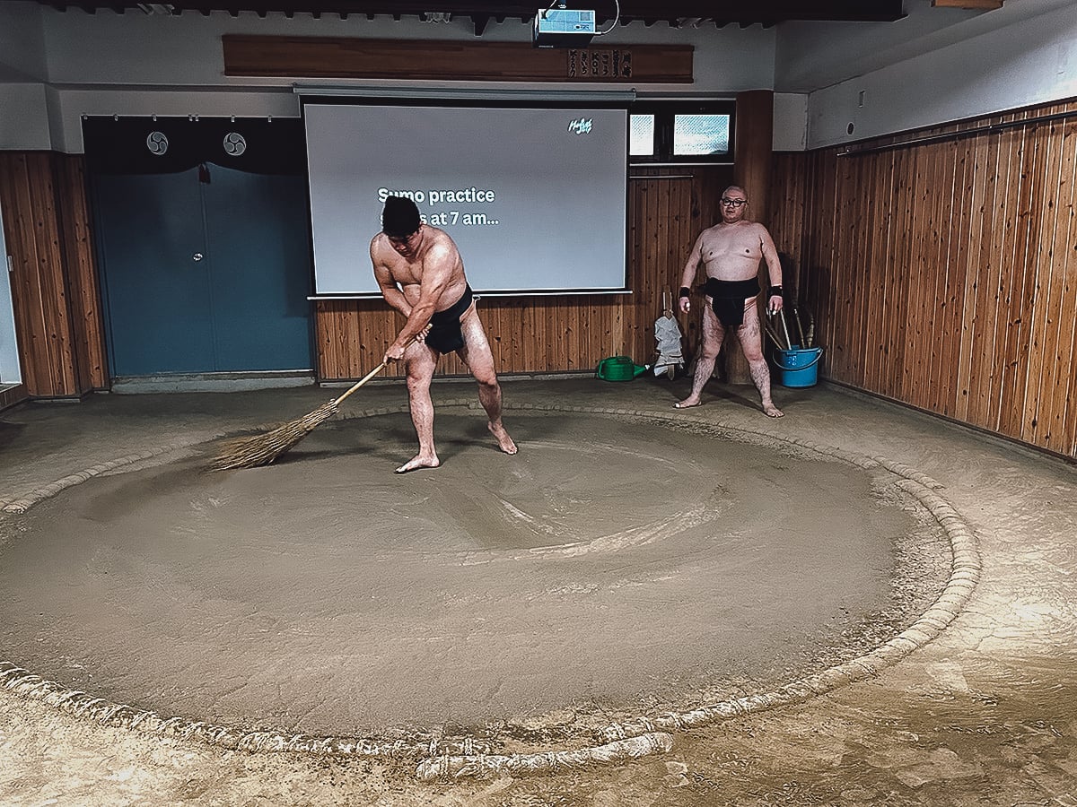 Sumo Experience in Tokyo Retired Sumo wrestler sweeping the ring