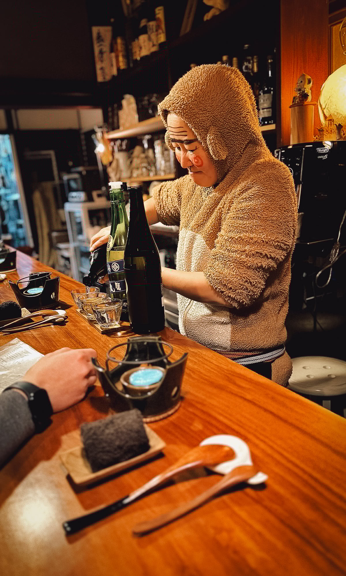 Veganic Monkey Magic Chef Monkey-san pouring sake