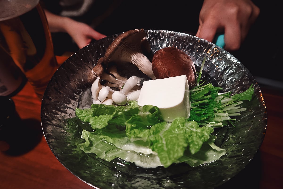 Veganic Monkey Magic Tofu, mushroom, and leafy greens hot pot