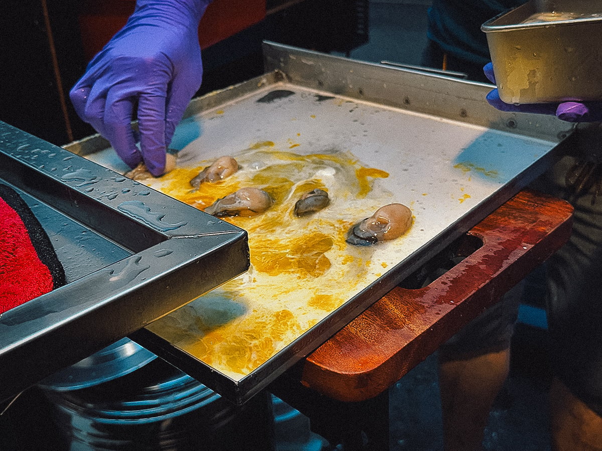 Night Markets in Taipei Preparing oyster flat noodle dish