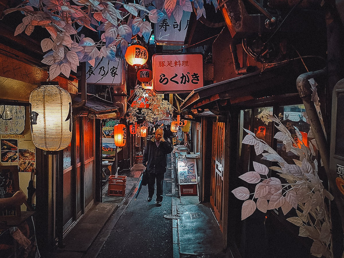 The Best Yokochos in Tokyo Japanese salaryman walking through Omoide Yokocho